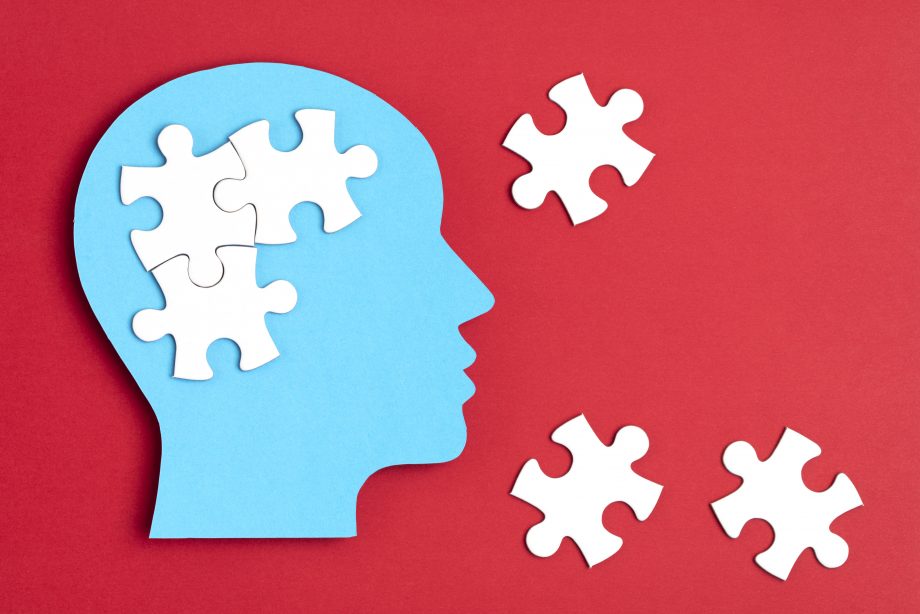 Papercut head with jigsaw puzzle pieces inside. Mental health problems, psychology, memory, logic, thinking process, solution, mental illness concept